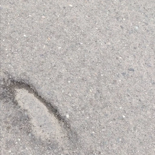 舗装面に損傷箇所がある道路画像
